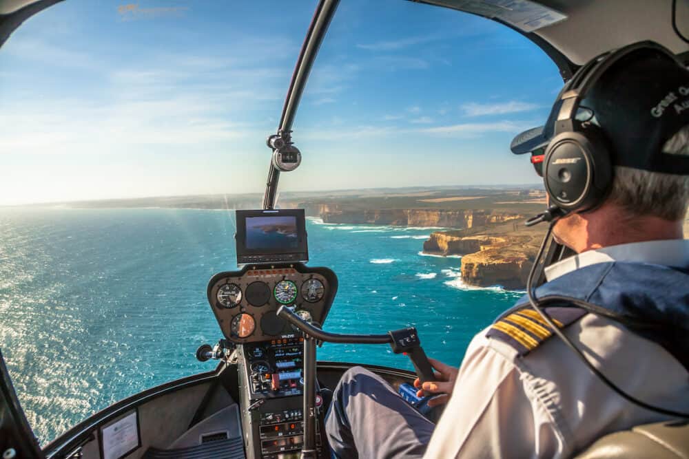 Port Campbell National Park, Victoria, Australia. Closeup of the cockpit of a helicopter and pilot who performs a scenic flight over the Twelve Apostles and the shipwreck coast