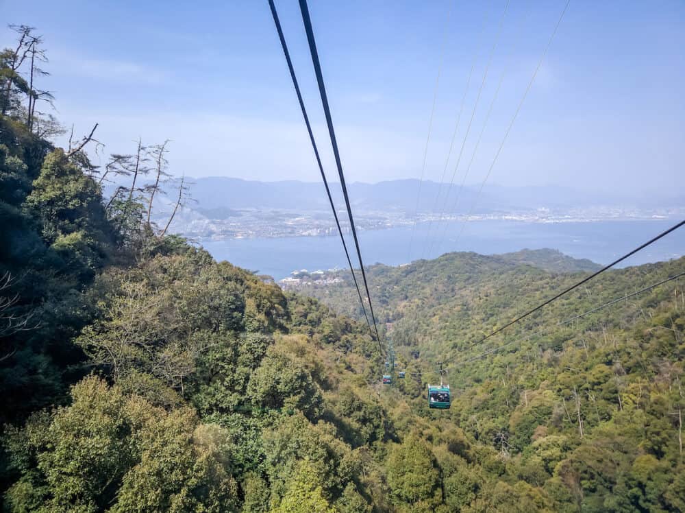 MIYAJIMA, JAPAN - Cable car to Mount Misen, height 535 meters, Miyajima island. Cable car cabins against the backdrop of the greenery of Miyajima Island.