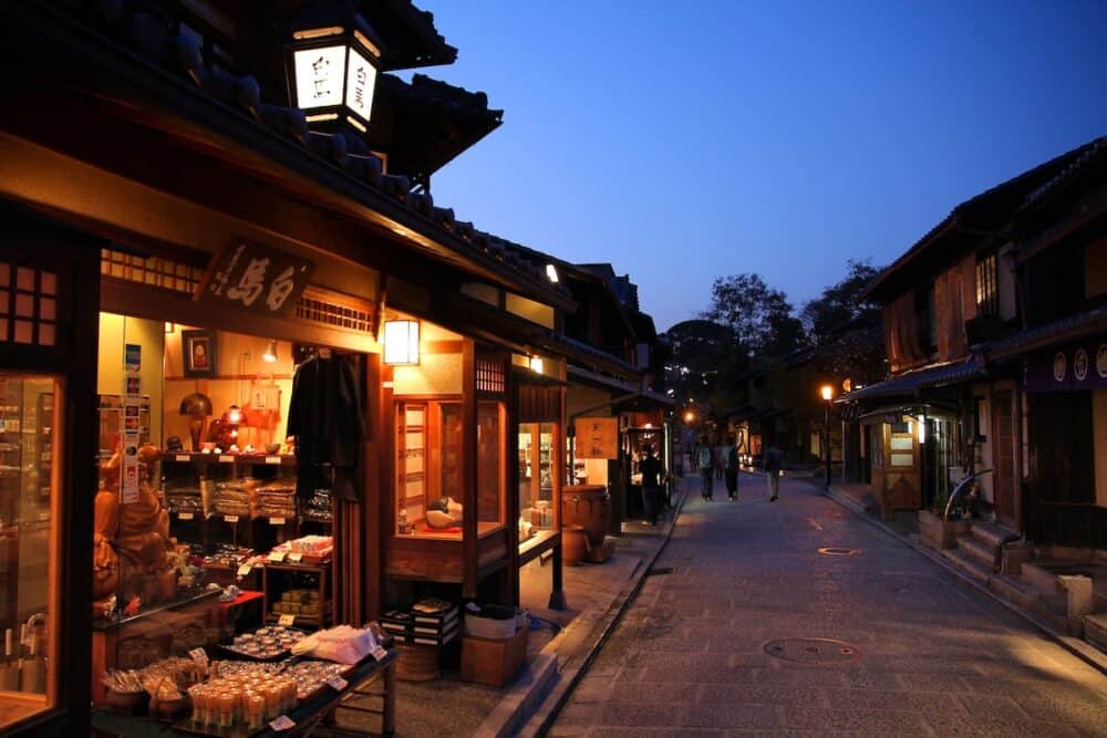 KYOTO, JAPAN - People visit evening streets of Higashiyama old town district in Kyoto, Japan. Old Kyoto is a UNESCO World Heritage site.