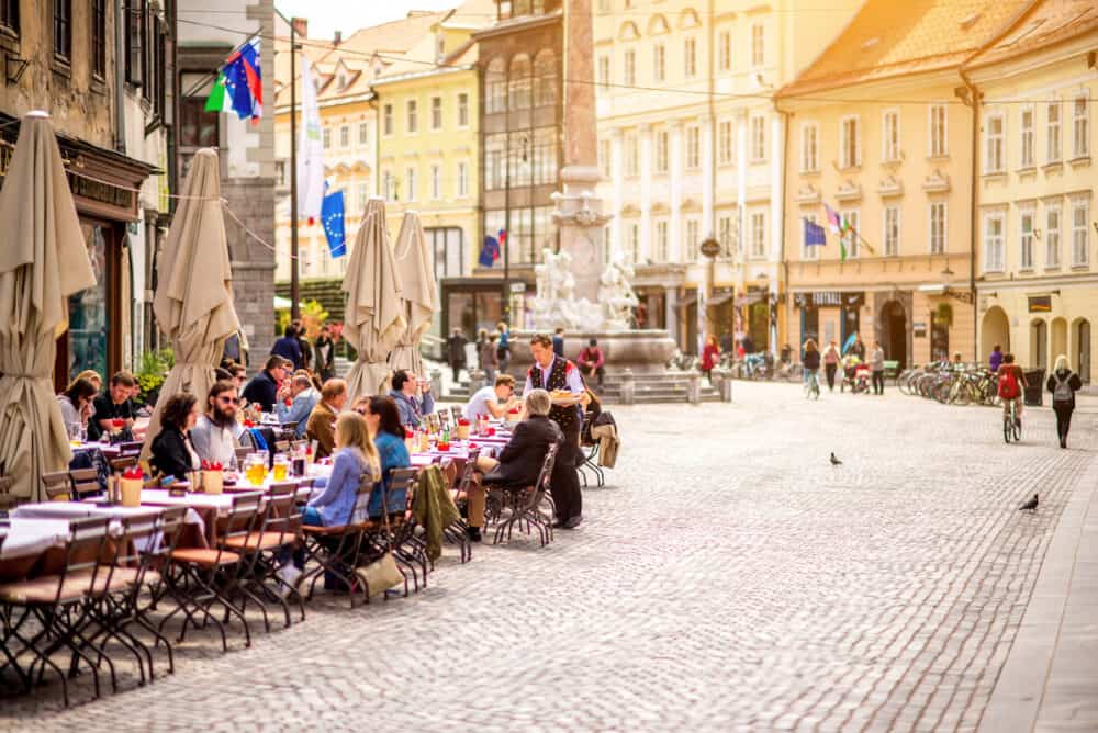 Ljubljana, Slovenia -People sitting at the cafe in the old city centre near the city hall in Ljubljana. Ljubljana is the capital of Slovenia and famous european tourist destination.