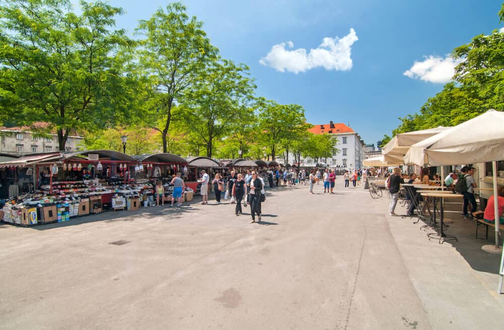 Ljubljana Slovenia -  People walking and shopping in Ljubljana's central market on a bright sunny day
