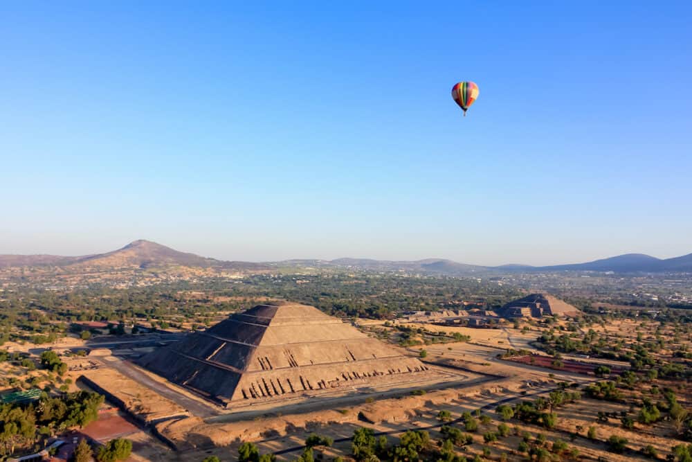 Hot air ballon  in light-blue sky over the pyramids of Teotihuacan Sun and Moon in Mexico.  Aerial view