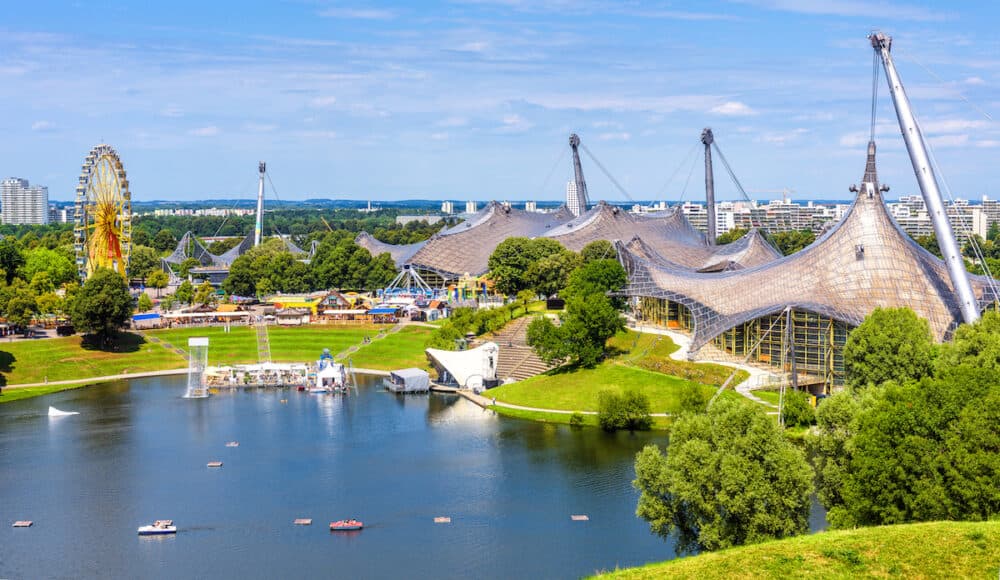 Munich - Olympic Park in summer, Munich, Germany, Europe. This place is landmark of Munich. Panorama of green Olympiapark, urban landscape. Scenic view of Munich amusement district, skyline of Munchen city.