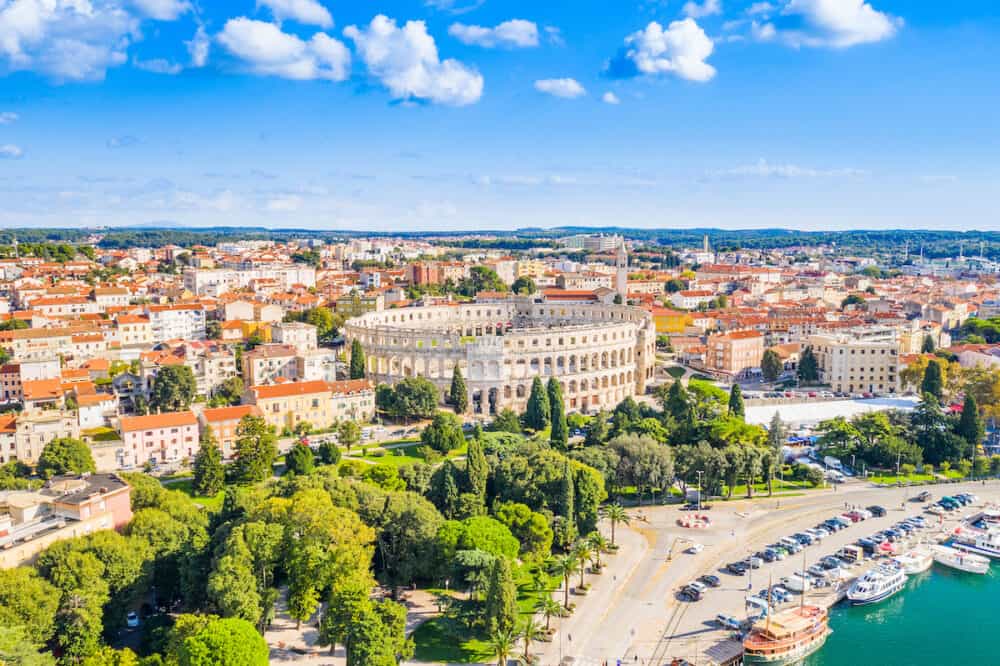 Croatia, city of Pula, ancient Roman arena, historic amphitheater and old town center from drone, aerial view