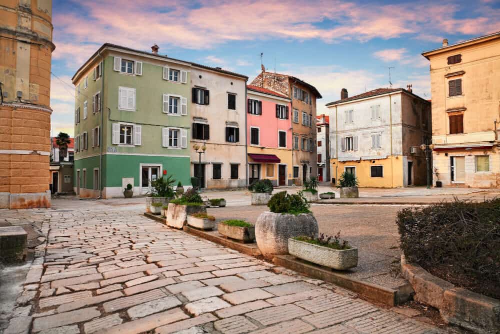 Porec, Istria, Croatia: picturesque cityscape at sunrise of an ancient square in the old town