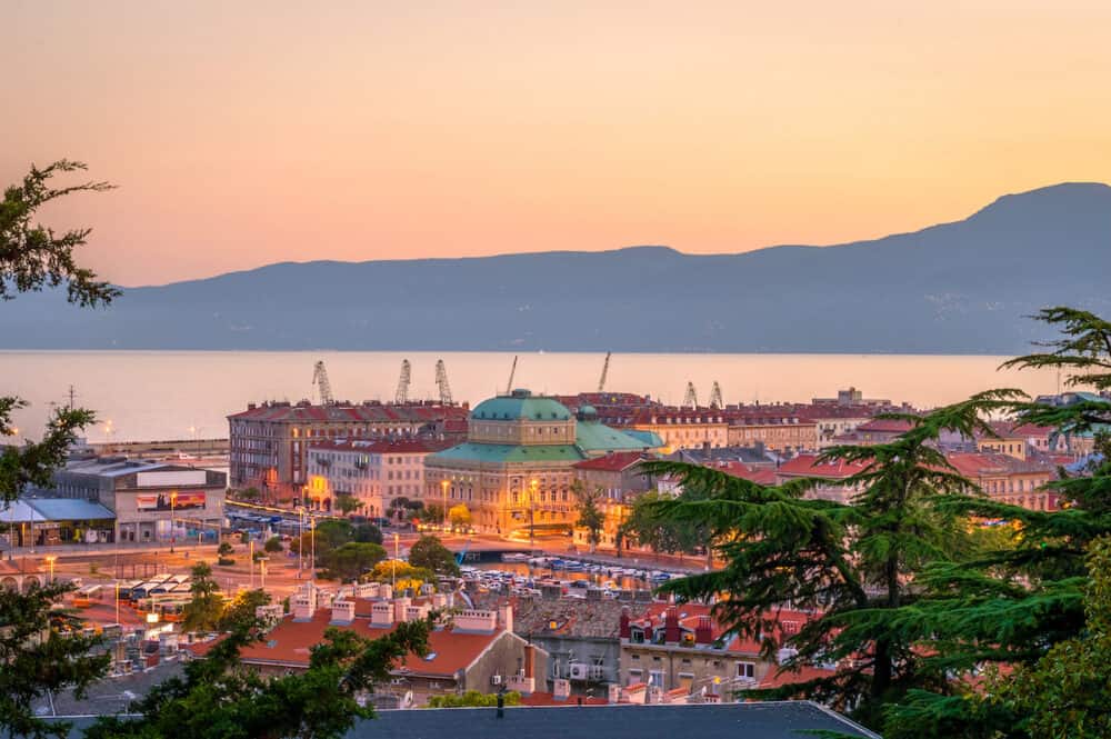 RIJEKA, CROATIA - A panorama of Rijeka city and the bay, with Croatian National Theater in the center and the harbour in the distance at the sunset. a View from the upper town, in the summer 