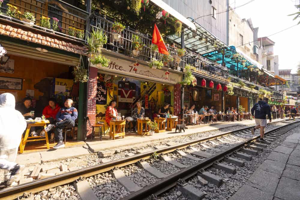 Hanoi, Vietnam - the passage of a train along the tracks between the houses of the old district of the city centre