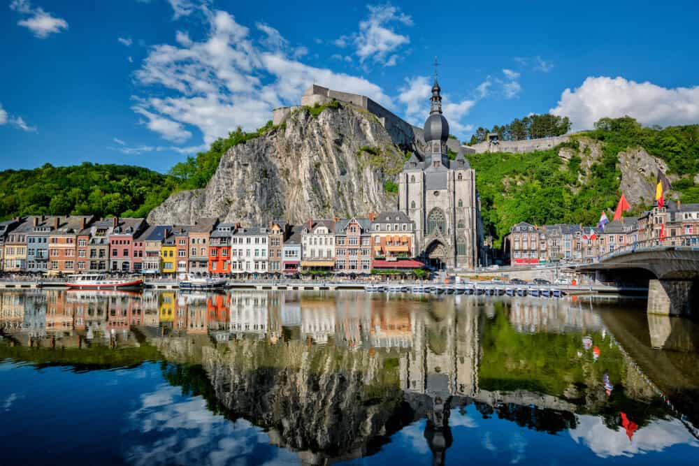View of picturesque Dinant town, Dinant Citadel and Collegiate Church of Notre Dame de Dinant and Pont Charles de Gaulle bridge over the Meuse river. Belgian province of Namur, Belgium