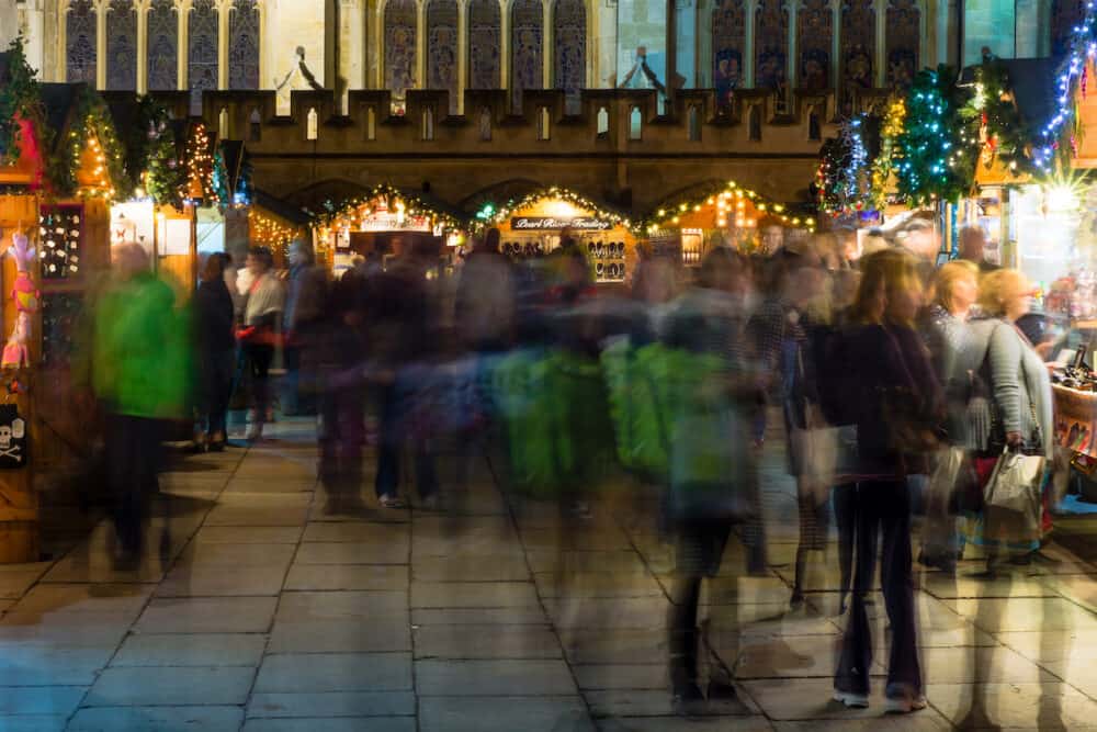 BATH, SOMERSET, UK - The annual Christmas Market in the evening in front of the Abbey