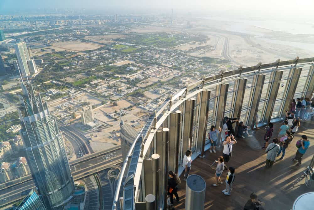 Dubai, UAE - Tourists meet sunrise at the observation deck on the 125 floor of Khalifa tower