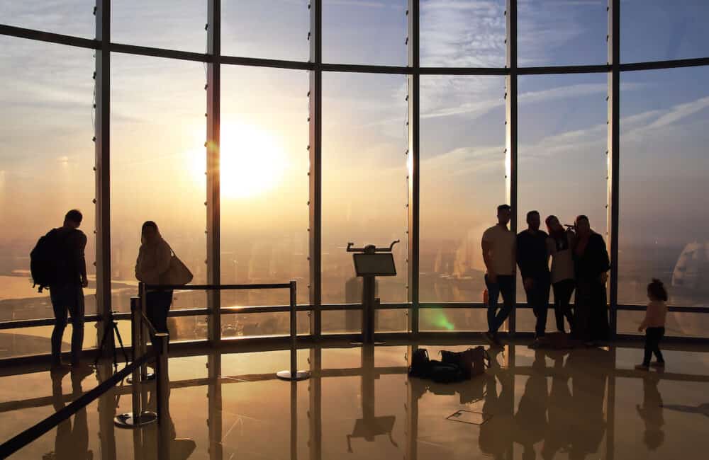 Tourists meet sunrise at the observation deck at the top of Burj Khalifa.