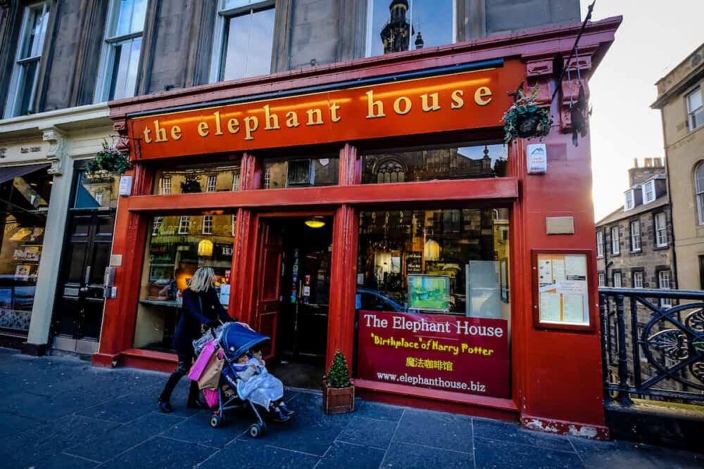 EDINBURGH, SCOTLAND - Woman with trolley walks by The Elephant house cafe, made famous as the place of inspiration to writer J.K. Rowling, author of Harry Potter.