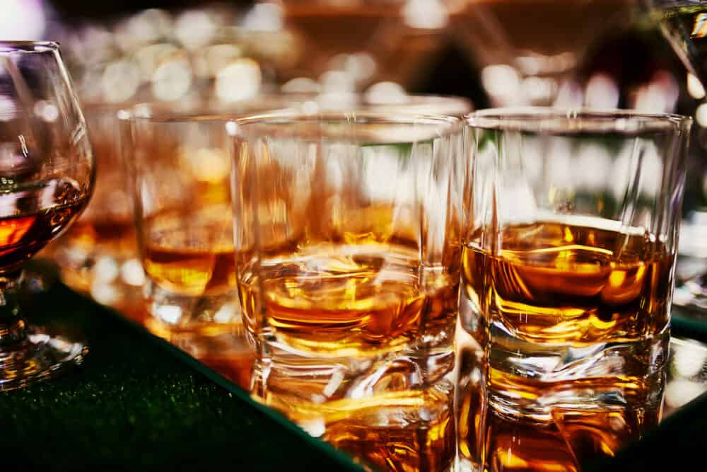 Glasses of whiskey on bar background. lots of glasses of whiskey. glasses of whiskey or brandy. selective focus
