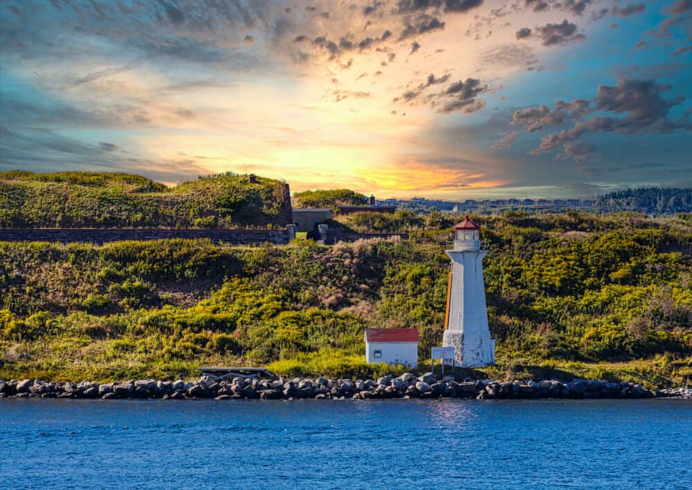 Small white and orange lighthouse on coast of Halifax, Nova Scotia