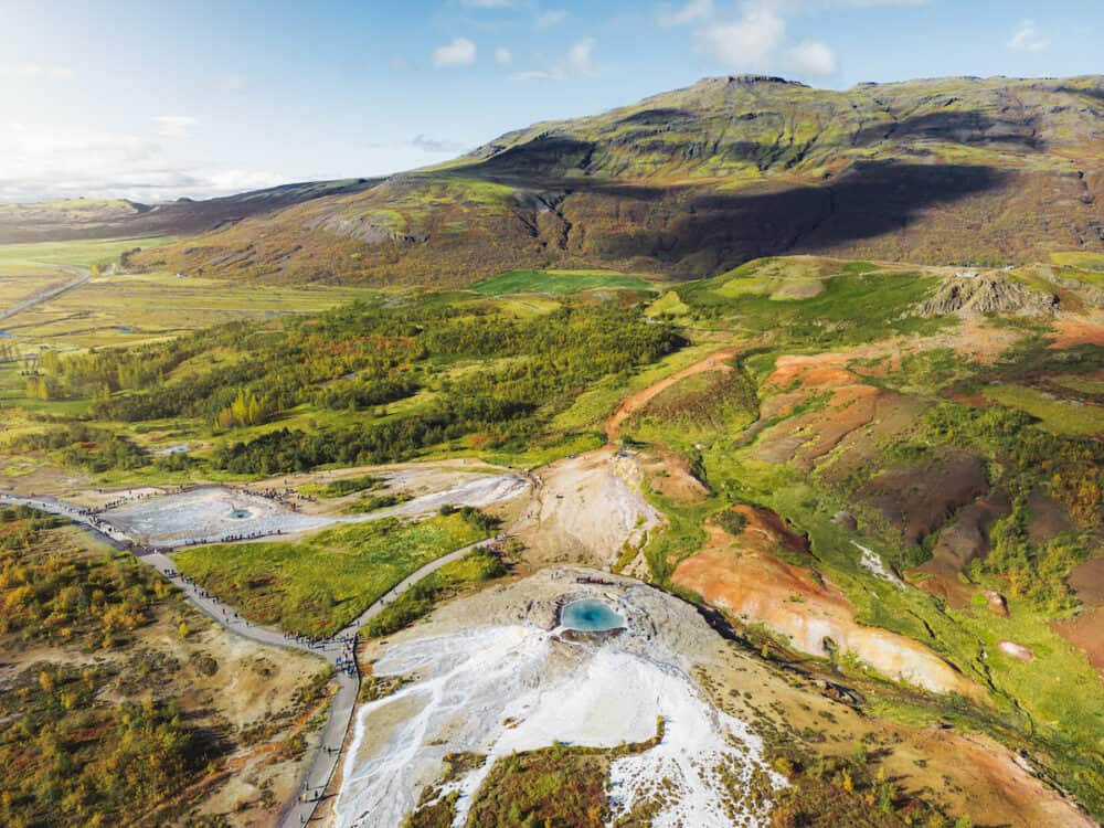 Vibrant green hills and nutrient rich land near geyser Strokkur in Iceland