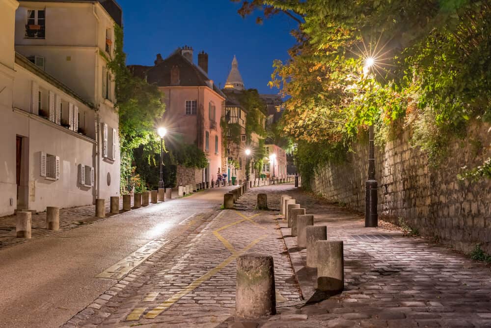 Empty street and the Sacre-Coeur at night, quarter Montmartre in Paris, France