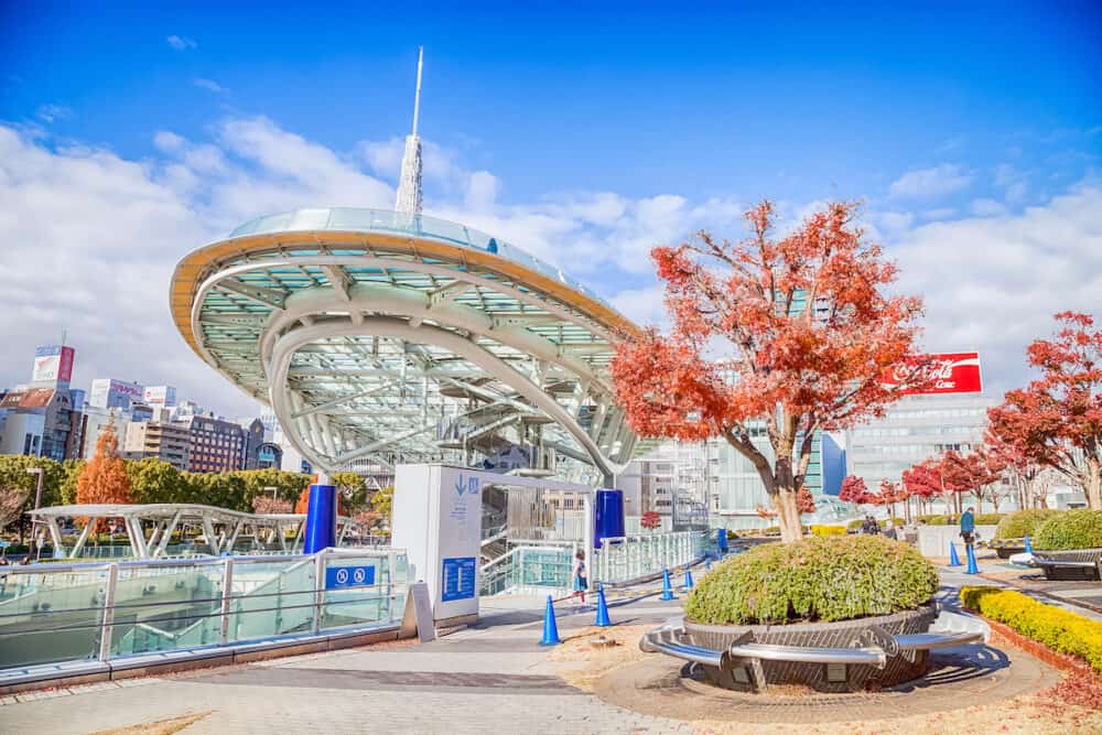 NAGOYA, JAPAN - Cityscape of Nagoya in autumn Oasis 21 and Nagoya TV Tower in Sakae, Japan., A shopping complex and its large oval glass roof structure floats above ground level.