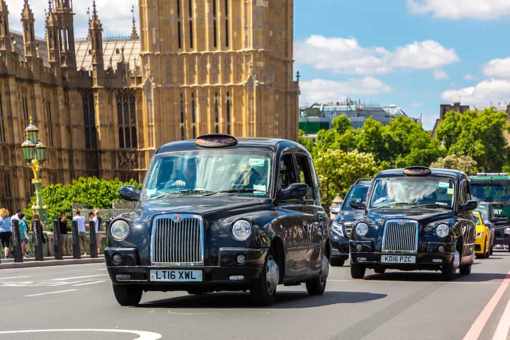 LONDON, THE UNITED KINGDOM -Symbols of London - Big Ben, Palace of Westminster and London taxi (Black Cab) on the Westminster Bridge in London, England, UK