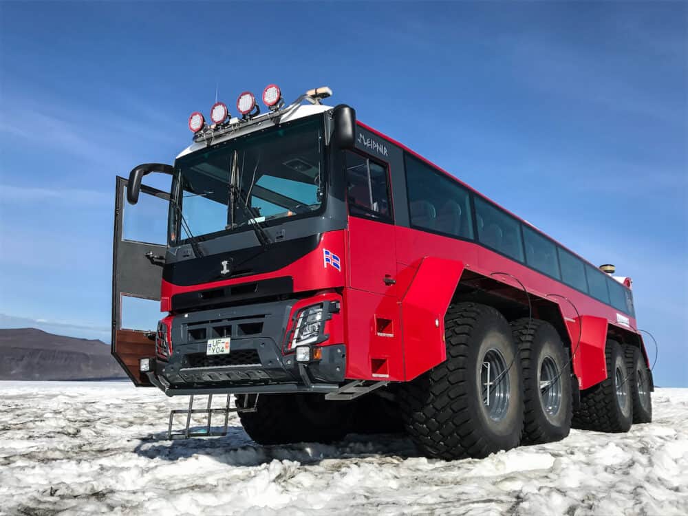 Red specialty vehicle for driving on the snow stands on the surface of Langjokull glacier. This is a part of "Into the Glacier" operation.