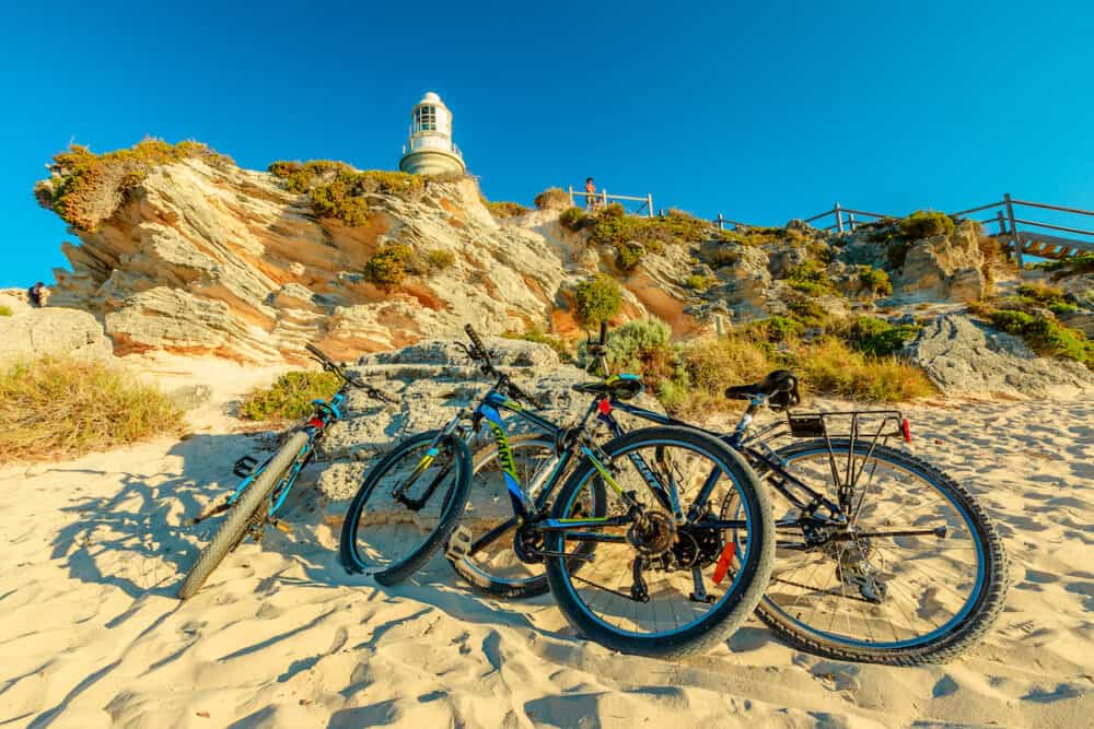 Rottnest Island, Western Australia - Tourist bicycles parked at Bathurst Lighthouse in north coast of Rottnest Island, near Perth, Western Australia. Sunny afternoon with blue sky.