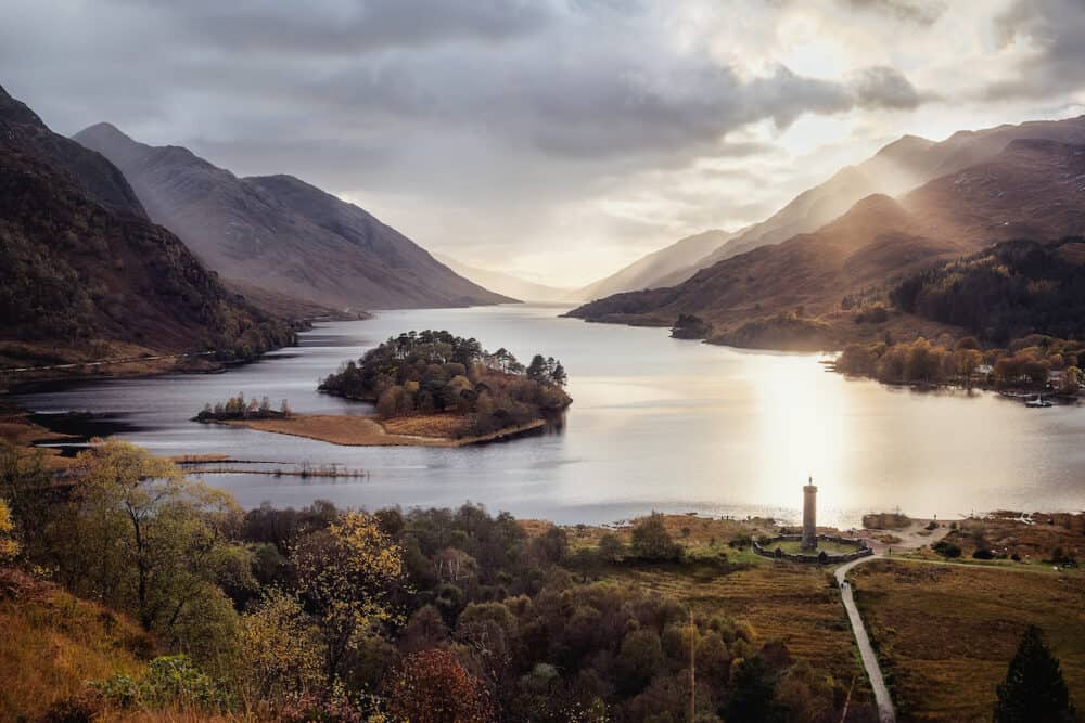 Panoramic view with famous Scottish lake Loch Shiel with Glenfinnan monument and island on sunset, Scotland.