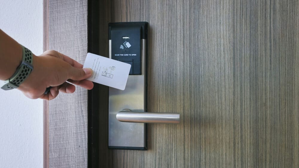 Smart card door key lock system in hotel. Hotel electronic lock on wooden door. Entrance door with electronic card lock security. Digital door lock security systems for access protection of hotel