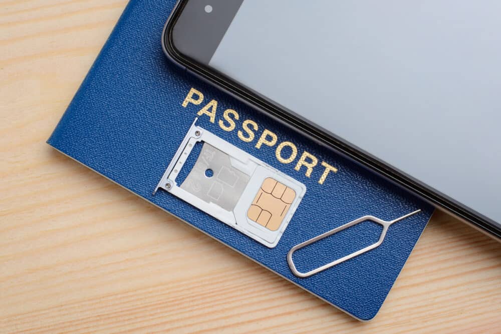 Tray for SIM card and micro sd memory drive from modern mobile phone on a national passport. Registration and identification SIM card for mobile phone using passport