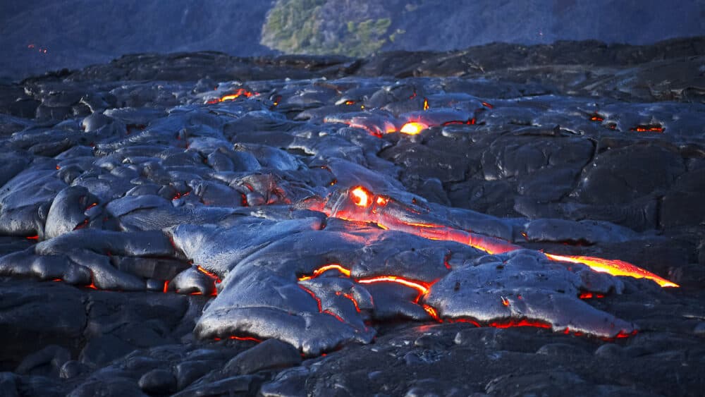 wide shot of a lava flow from kilauea volcano in hawaii