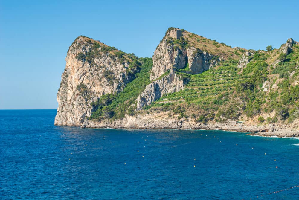Three mountain laces of the bay of Ieranto, of Massa Lubrense, with the Montalto Tower on the summit, taken from the beach of Nerano, near Sorrento