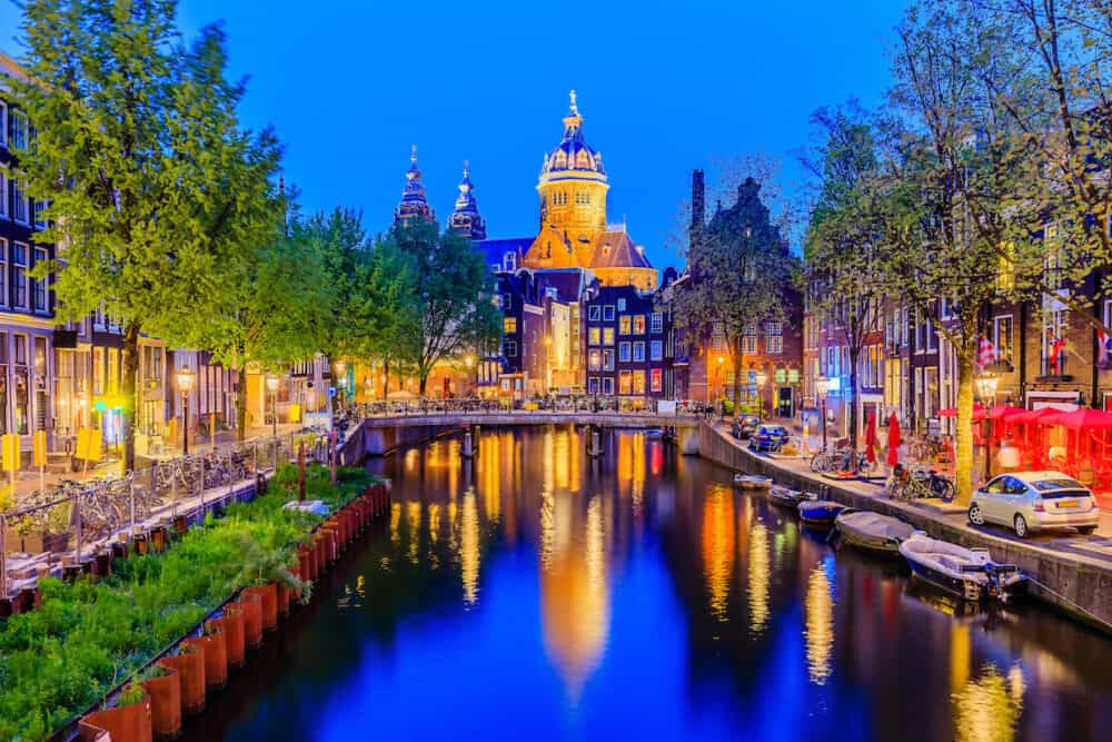 Amsterdam, Netherlands. Basilica of Saint Nicholas and canal houses of Amsterdam.