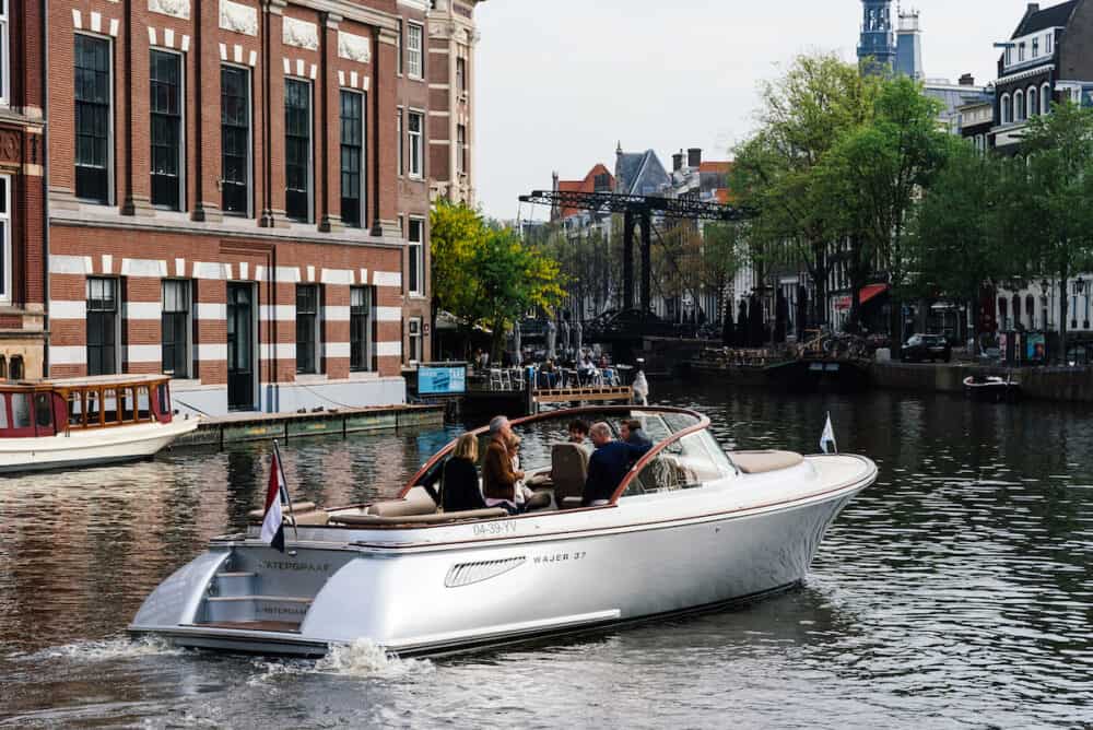Amsterdam, Netherlands - Luxury boat navigating by Amstel River