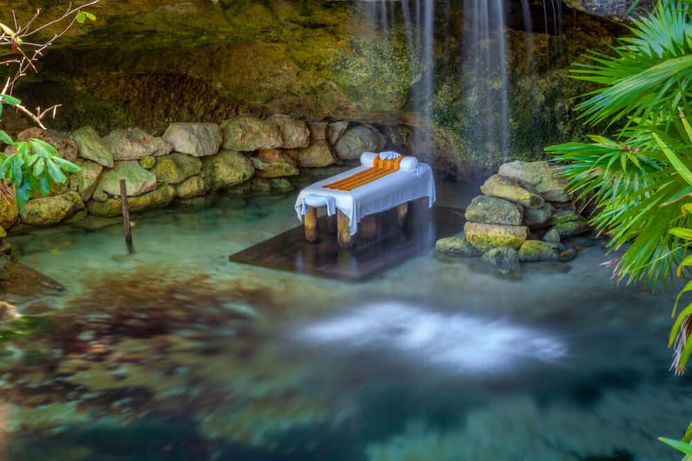 Massage Booth bed in a peaceful corner with lake and waterfall, Cancun, Mexico