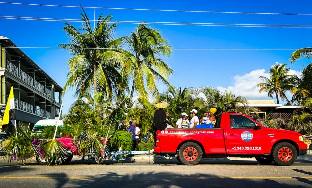 Grand Cayman, Cayman Islands,  view of some people in the back of a red pickup parading during the carnival