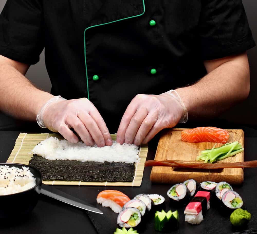 Chef making sushi .Sushi roll process of making raw makki fresh seafood susi.