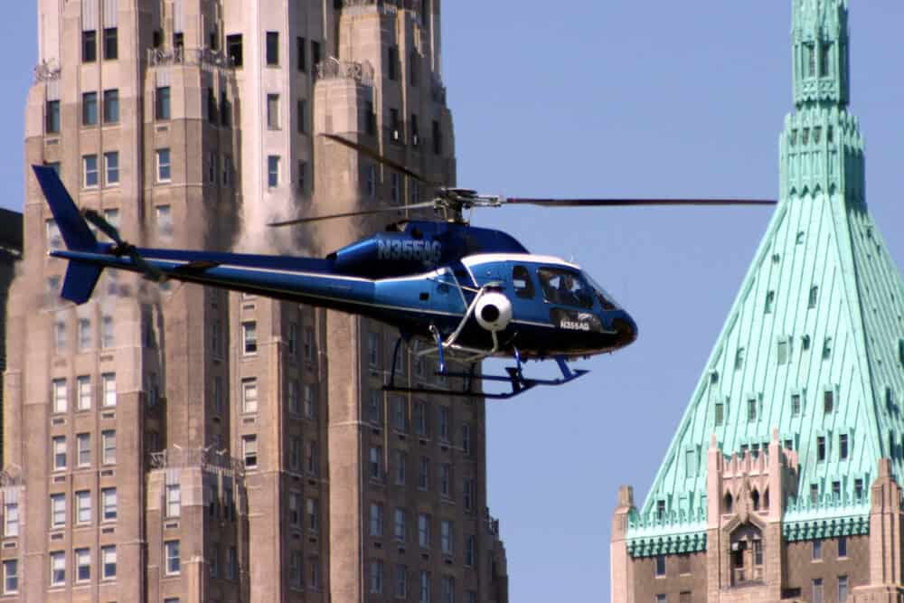 A helicopter flying in front of New York buildings