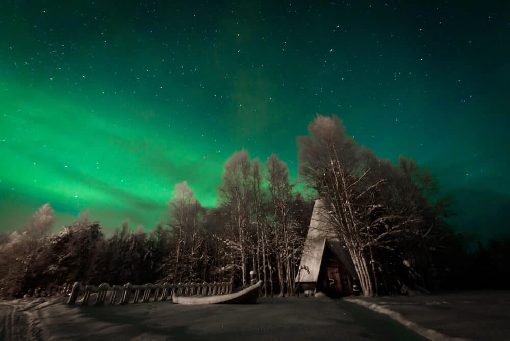 The northern lights Aurora Borealis at Kuukiuru village lake in Lapland Finland