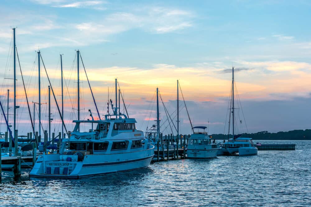 Boats at the Panama City Marina docked with a sunset in the background.
