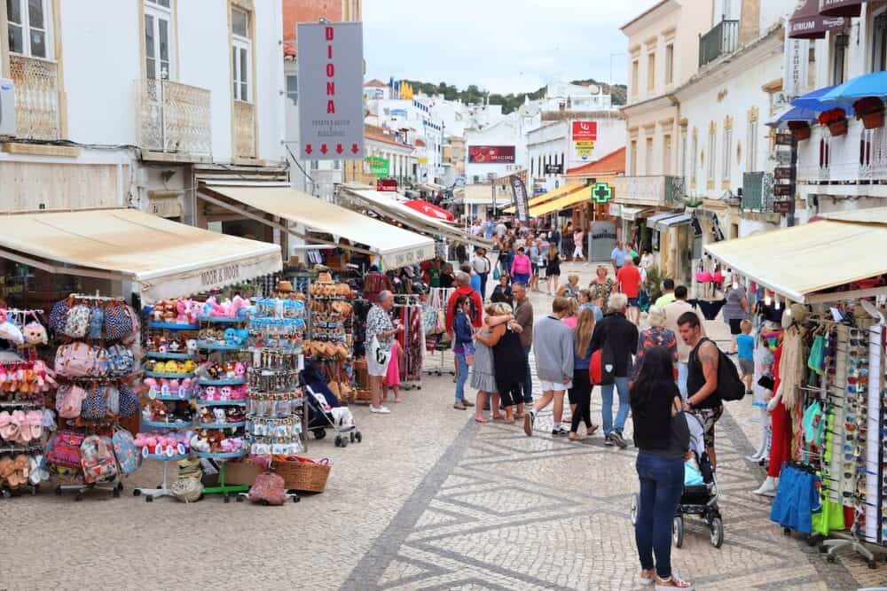 People visit downtown Albufeira, Portugal. The town is a popular tourism destination and has significant expat population.