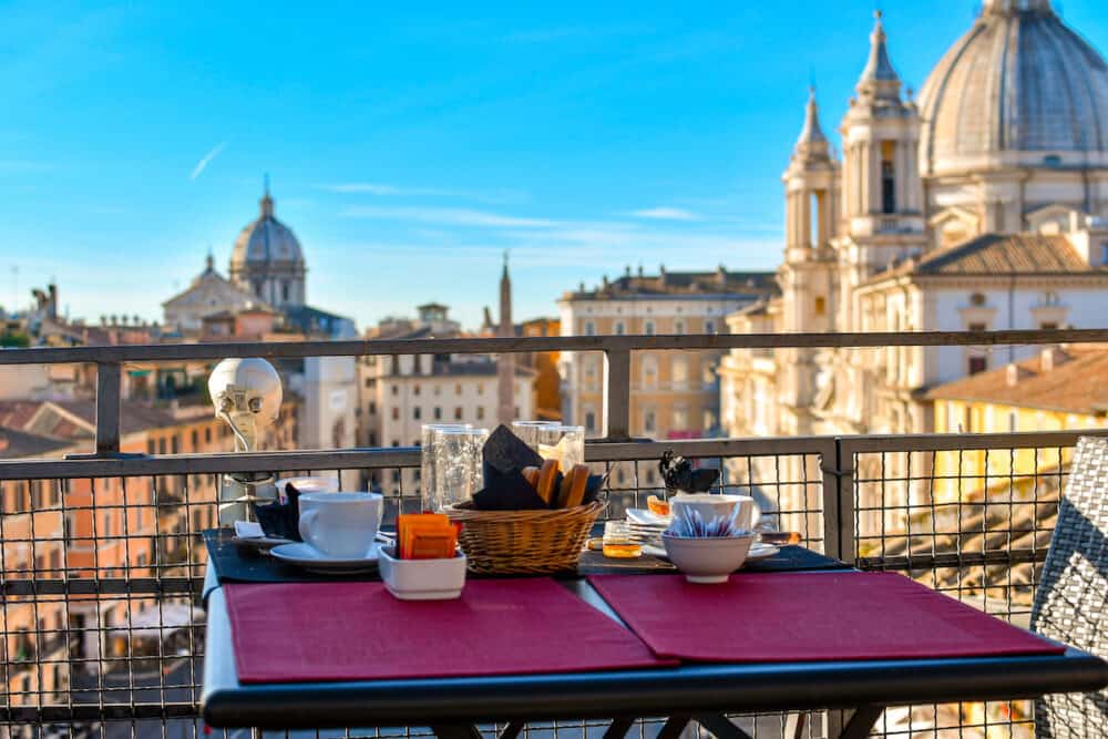 Leftovers from a continental breakfast on a roof top bar overlooking the Piazza Navona on an early summer morning in Rome, Italy.