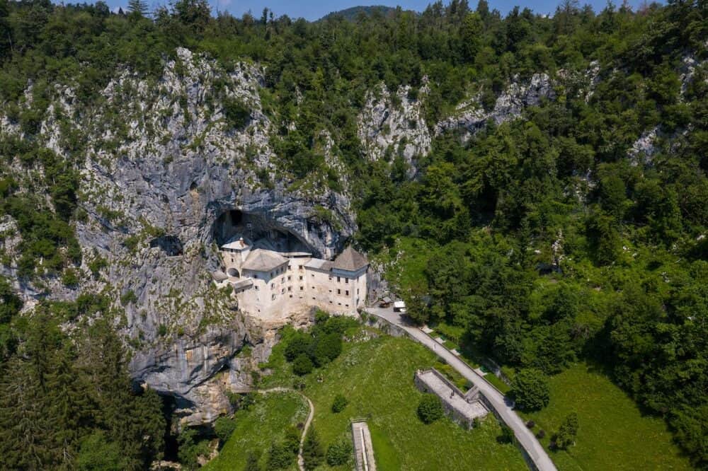 Predjama Castle in Slovenia, Europe. Renaissance castle built within a cave mouth in south central Slovenia, in the historical region of Inner Carniola. It is located in the village of Predjama. Drone