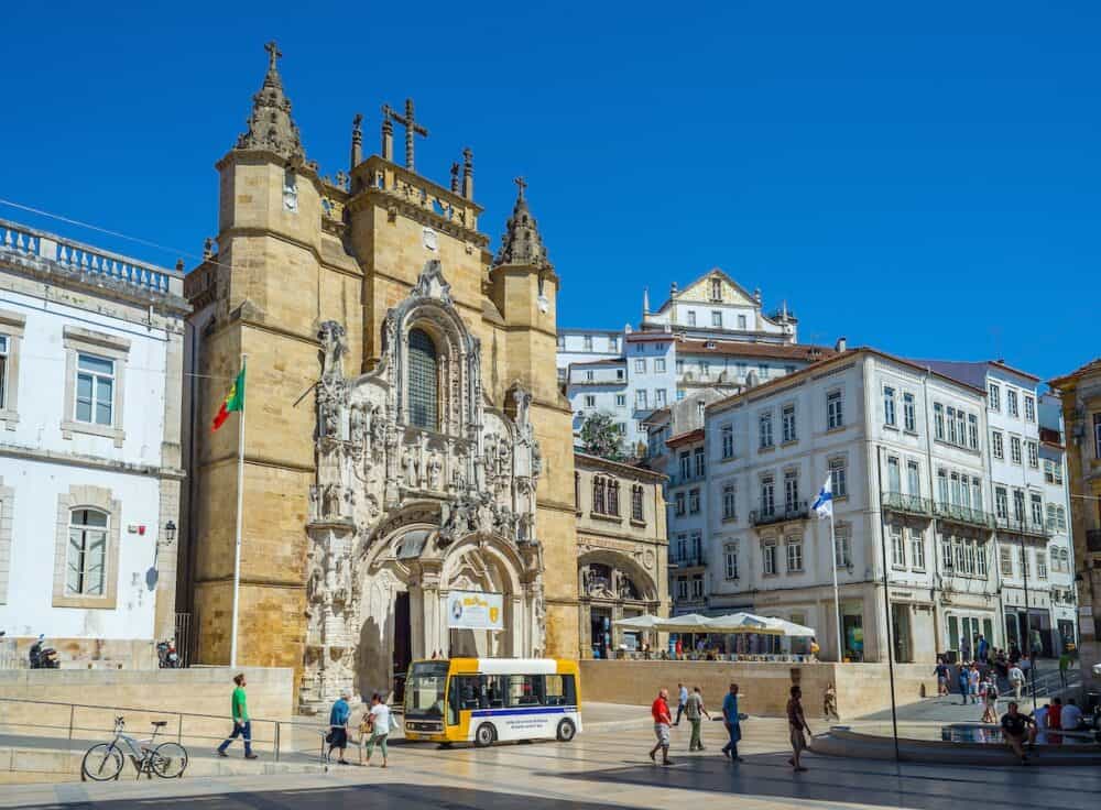 Historic centre bus in front of Santa Cruz church in Praca 8 de Maio square. Coimbra Portugal.
