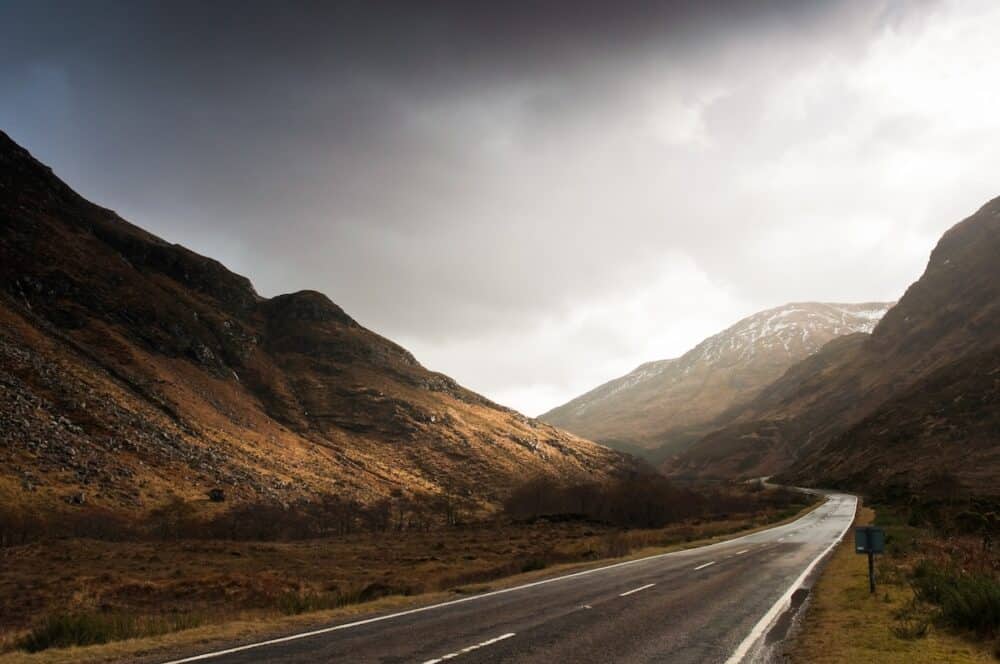 Open road leading through the dramatic Scottish Highlands of Glen Coe Scotland.