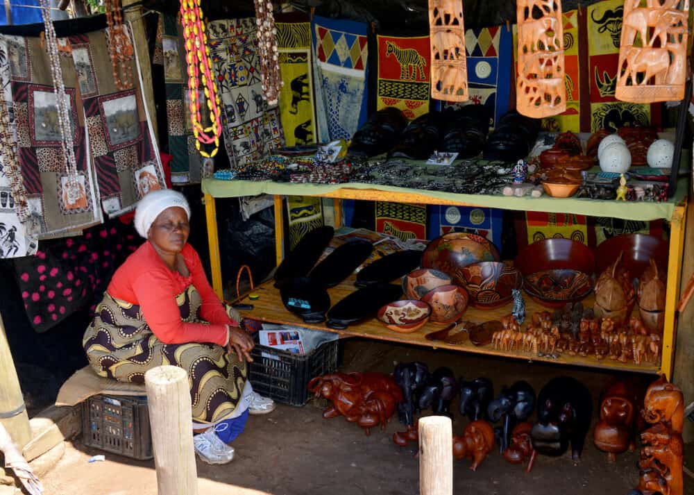 Unidentified african  woman selling hand made art on the market for tourists on the panarama route.