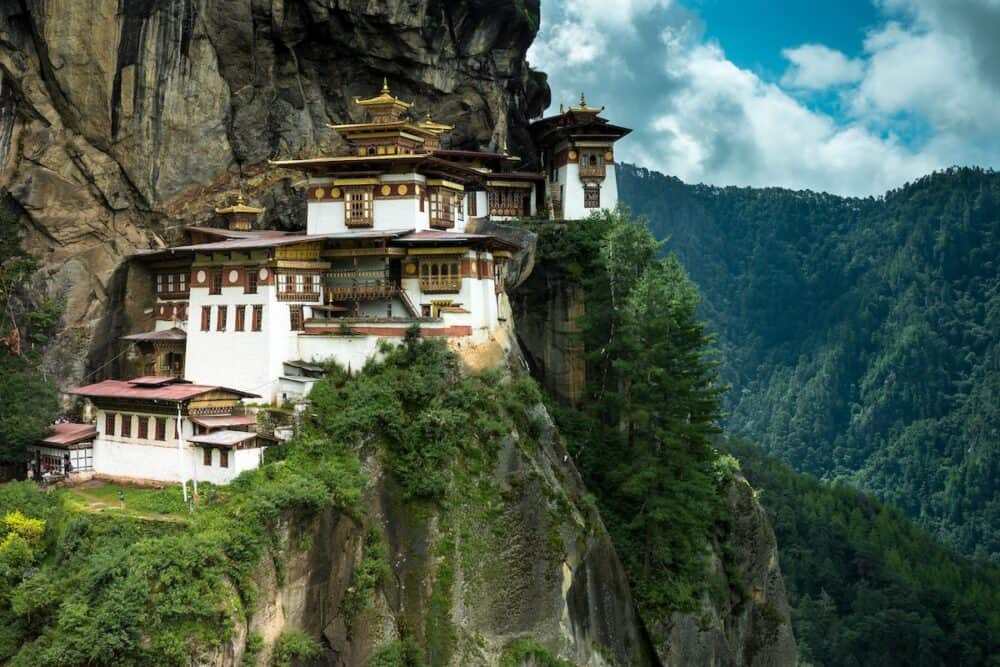 Paro Taktsang Monastery is the most famous buddhist temple complex of Bhutan which clings to a cliff 3120 meters above the sea level on the upper side of Paro valley Bhutan.