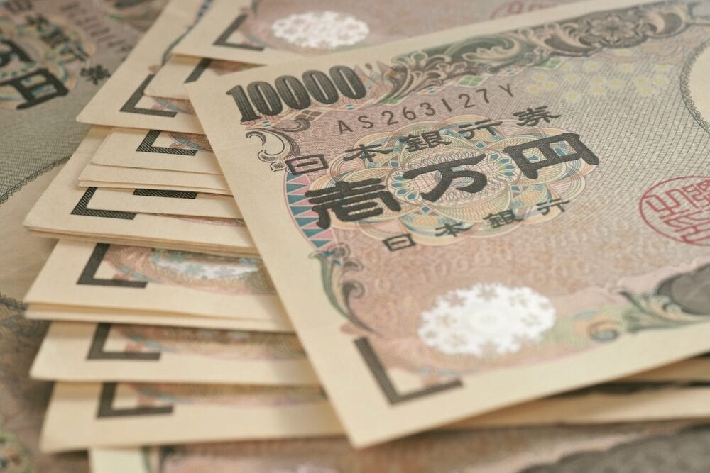 A field of 10000 yen Japanese notes Background or wallpaper with reduced contrast and color saturation A bundle of bills Backdrop on the theme of banks finance and the economy of Japan