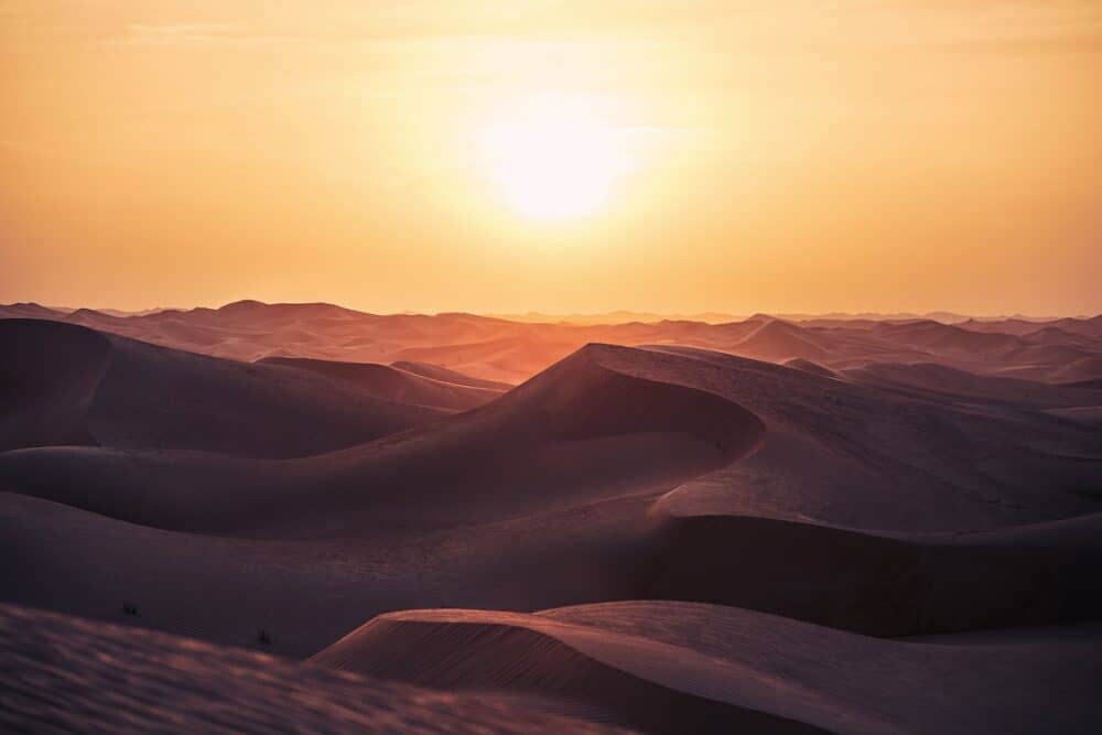 Heat day in desert landscape. Sand dunes at beautiful sunset. Abu Dhabi, United Arab Emirates
