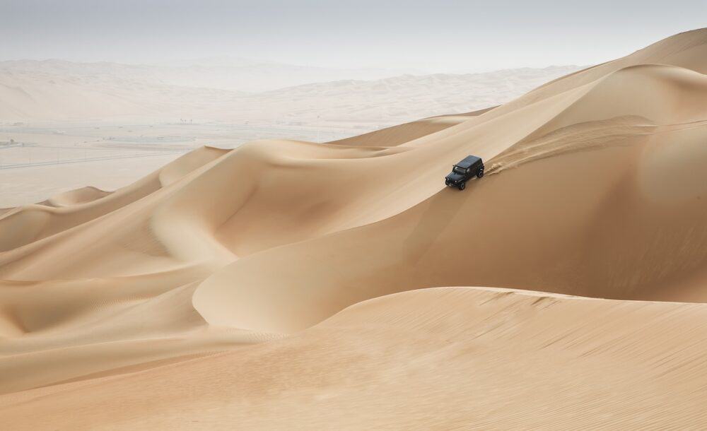 car driving in Rub al Khali Desert at the Empty Quarter in Abu Dhabi United Arab Emirates