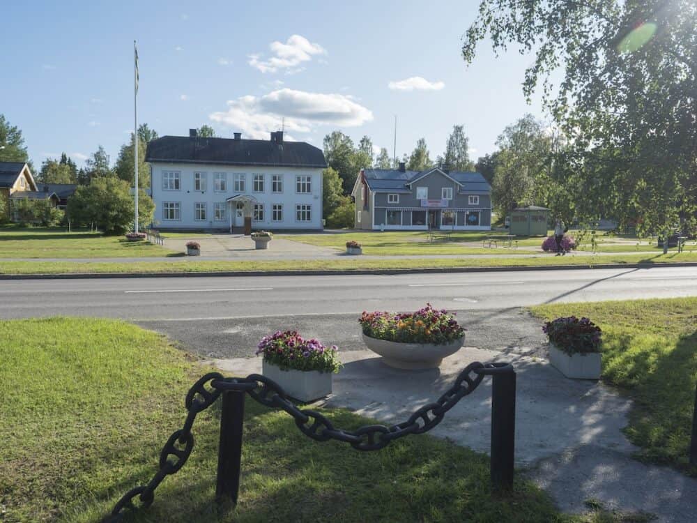 Jokkmokk, Norrbotten, Sweden. Flower decorations and houses on main street at Jokkmokk