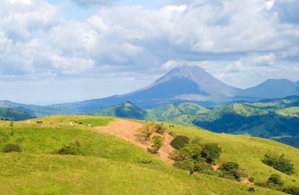 Landscape showing Costa Rica pastureland with Arenal Volcano in the background.