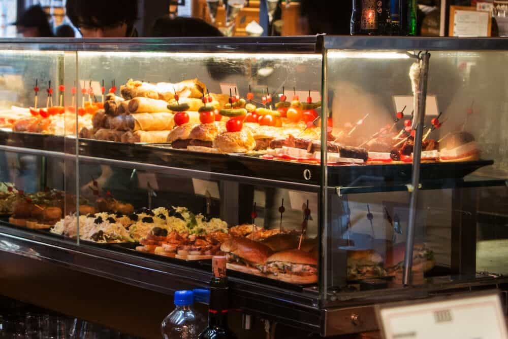 MADRID SPAIN - Glass case with different tapas at Madrid San Miguel market Spain.